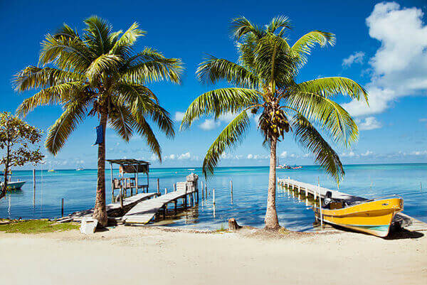 Belize tours to beachside docks with boat.