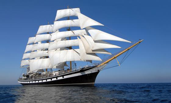 Guests sailing aboard the Tall Ship Silva in Halifax Harbour with views of the waterfront and historic landmarks.
