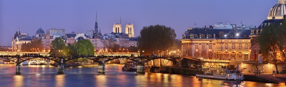 Twilight cityscape and Pont des Arts in Paris, France.