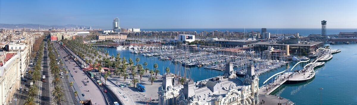 Port Vell port, boats and city street in Barcelona, Spain.