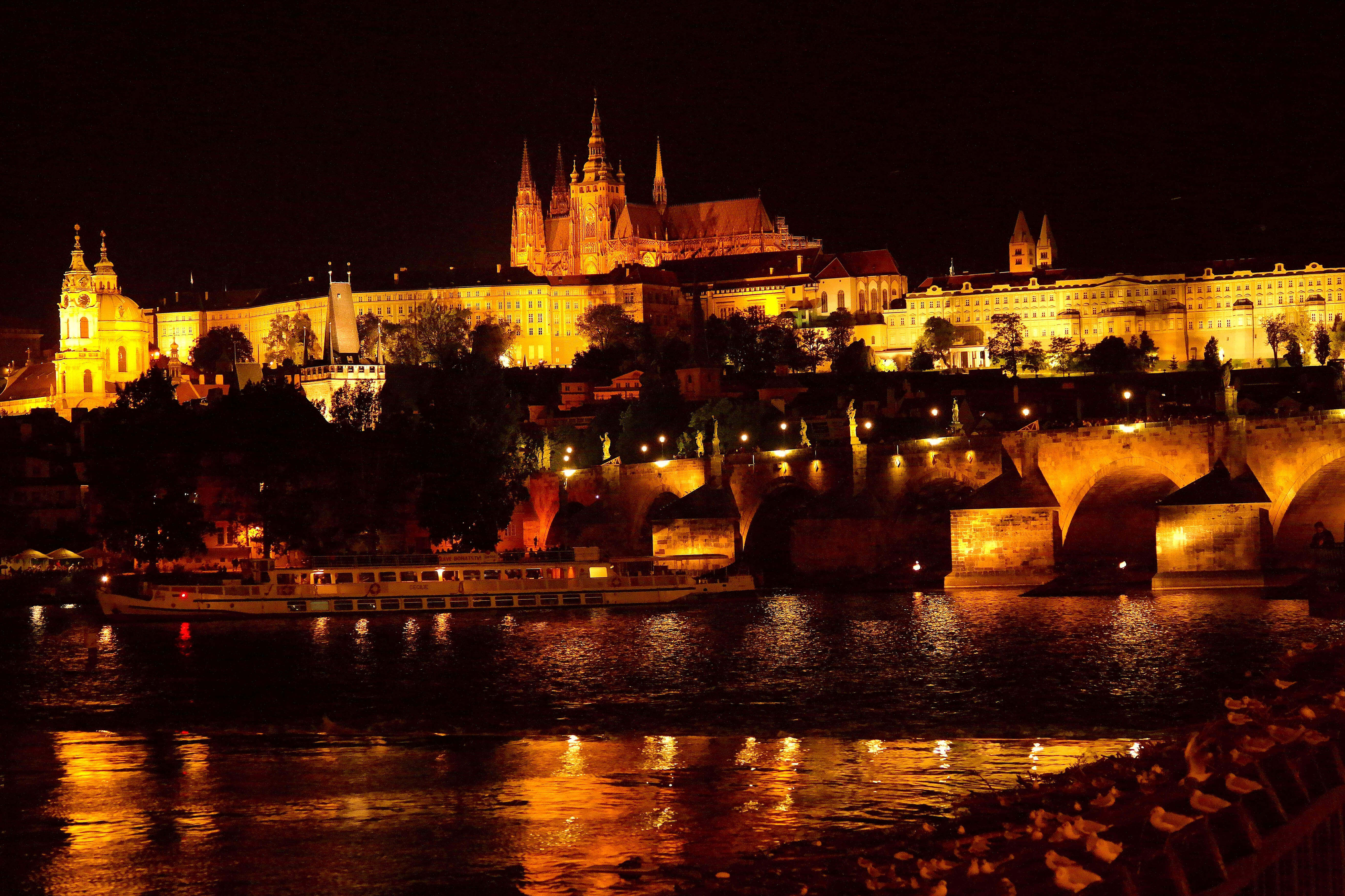 Prague Castle by canal at night in the Czech Republic.