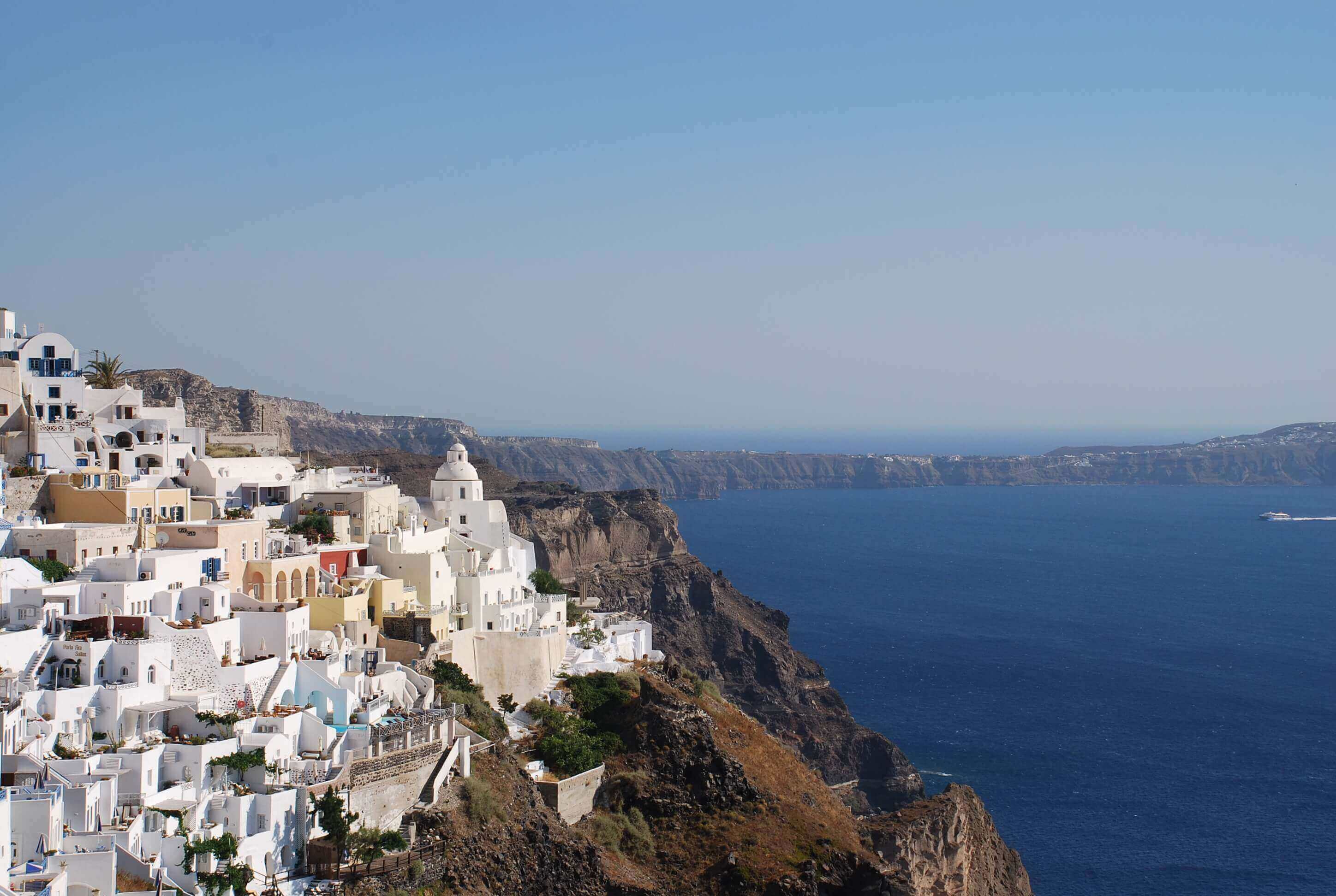 Cliffside village homes on Santorini, Greece coast.